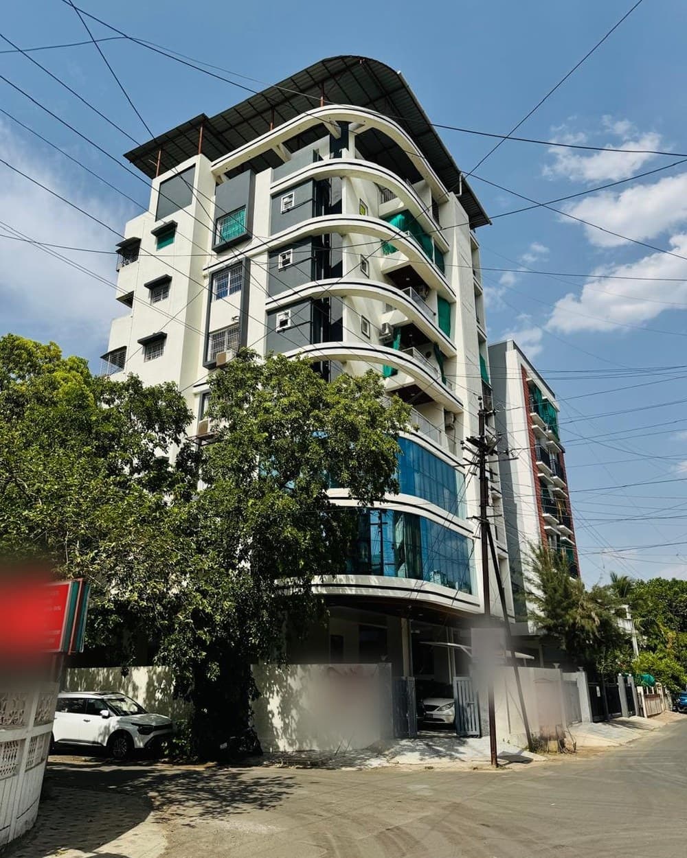 A glass-fronted apartment block — the photograph the client sent