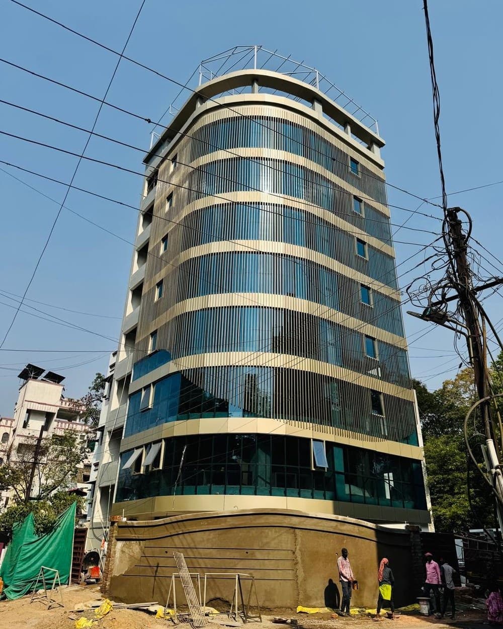 A curved tower, still under construction — the photograph the client sent